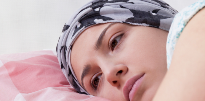 headshot of young woman wearing a headscarf, resting