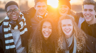 group of young people at sunset